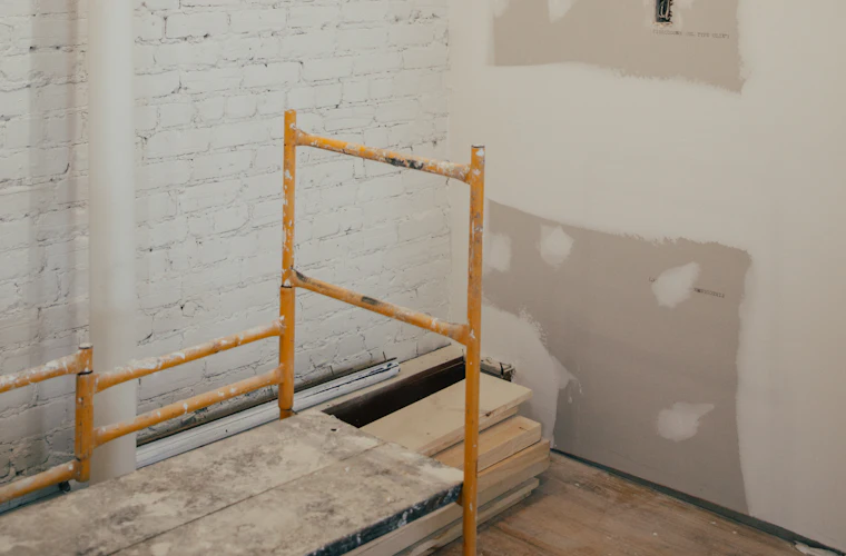 Patched and taped drywall repairs on an interior wall ready for sanding